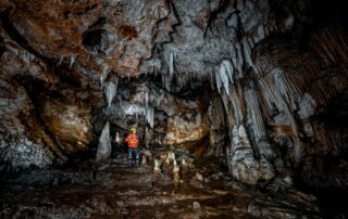 Speleologist exploring the wild chambers of Lipa Cave, Cetinje Montenegro