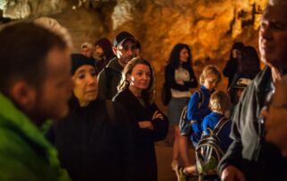 Visitors listening to a guide inside Lipa Cave, Cetinje Montenegro