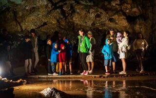 Children on a guided tour inside Lipa Cave, Cetinje Montenegro